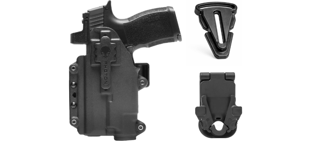 Black handgun in a modular polymer holster with separate belt clip attachments on a white background.