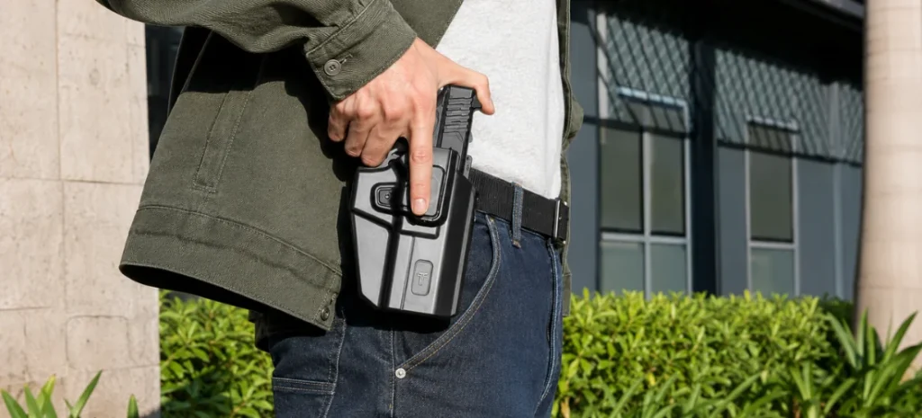 Man carrying a handgun in a gray OWB holster.