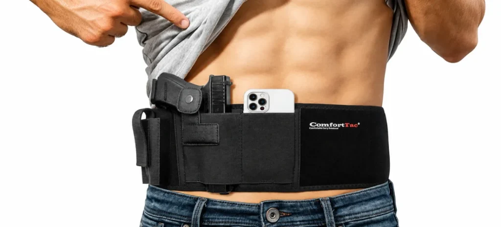 Close-up of a person wearing a black ComfortTac belly band holster with a handgun and smartphone.