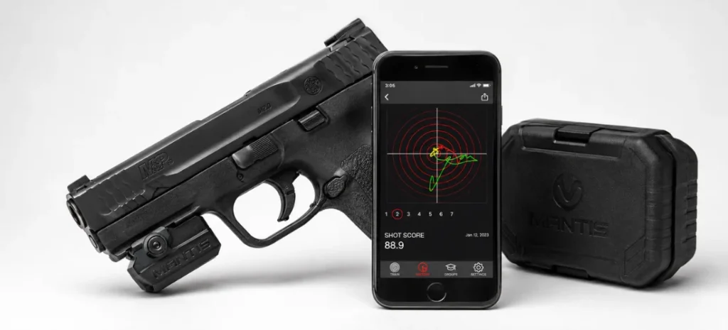 Mantis X3 sensor mounted on a pistol beside a smartphone displaying shot analysis and the system’s protective case.