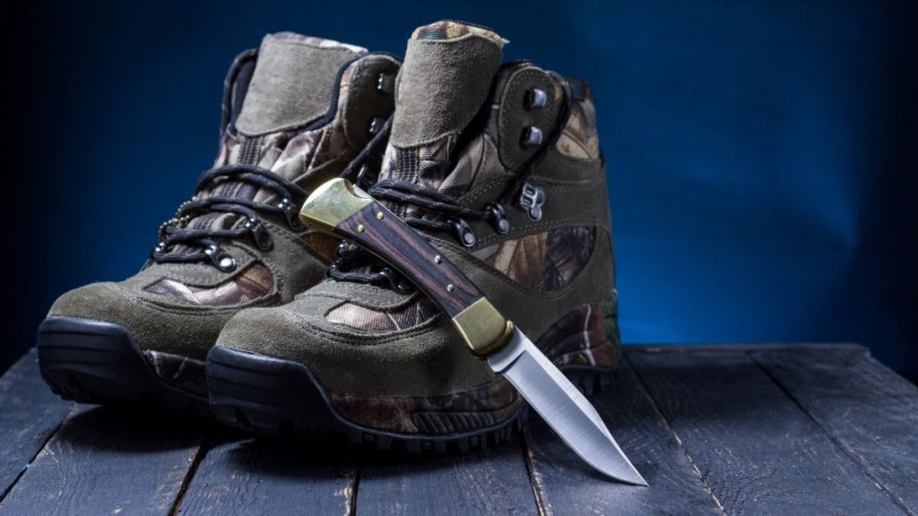 Pair of best hunting boots with a hunting knife
